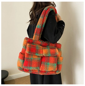 Detail of vintage plaid plush tote bag with two front flap pockets for winter