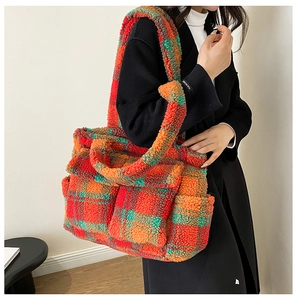 Detail of colorful plaid plush tote bag showing soft fuzzy texture and front pockets