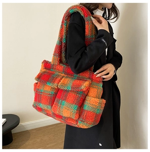 Detail of plush tote bag with autumn color plaid pattern and functional side pocket