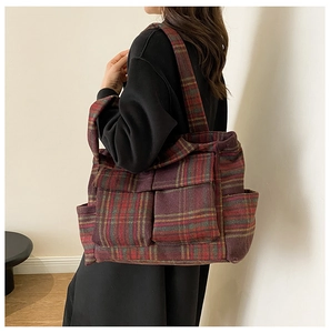 Detail of burgundy plaid plush tote bag with multi-pocket structure and large capacity