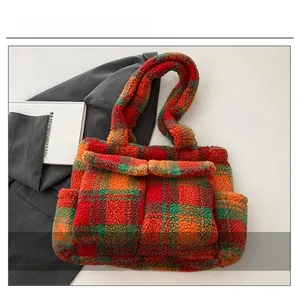Detail of colorful plaid plush tote bag featuring soft teddy fleece and front pockets