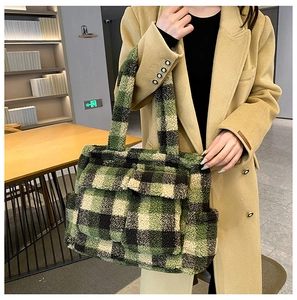 Detail view of a fuzzy plaid tote bag with front pocket and thick winter texture