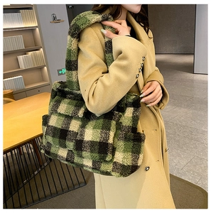Detail of green and yellow plaid plush tote bag styled with a khaki winter coat