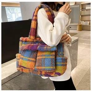 Detailed macro view of plush checkered tote bag with front pockets and soft fuzzy texture