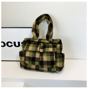 Detail of plush checkered tote bag with green and black wooly texture and front pocket