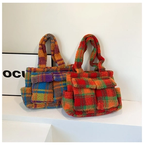 Detail of plush checkered tote bag featuring front cargo pockets and soft fuzzy texture