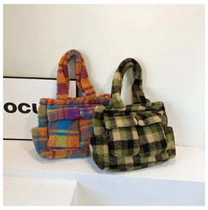 Detail of plush checkered tote bags with soft texture and multiple front pockets