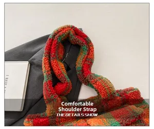 Close-up of the comfortable wide shoulder strap on a plush plaid tote bag