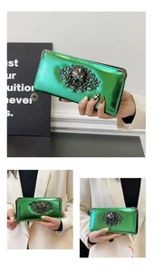 Macro shot of metallic green wallet featuring Gothic skull relief and corner metal protectors