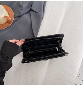 Detailed interior of long skull wallet showing multiple card slots and zipper pocket