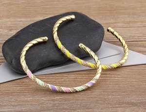 Detailed macro view of 18k gold plated bangle with colorful enamel and zircon stones