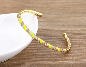 Detailed view of the 18k gold plated bangle with neon enamel and micro-set cubic zirconia