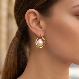 Close-up of elegant freshwater pearl earring with 18k gold plated teardrop frame