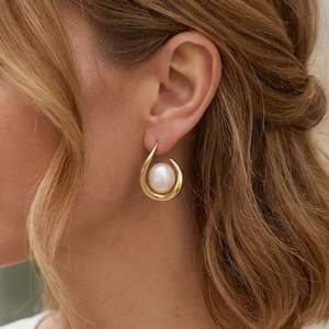 Elegant 18K gold plated copper earrings with large white freshwater pearl on model