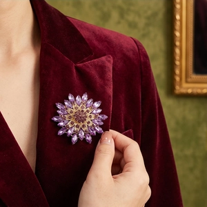 Elegant purple crystal flower brooch pinned on a luxury burgundy velvet blazer lapel