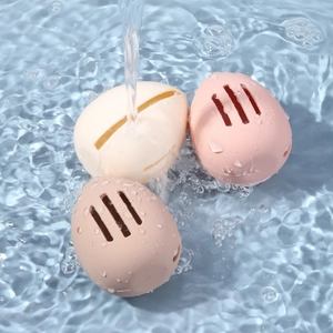 Three-piece silicone beauty blender case set in neutral tones under flowing water