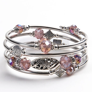 Detailed view of multilayer pink zebra stone wrap bracelet with floral pendant charms