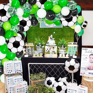 Soccer party decoration kit with green and black balloon arch and football gift bags
