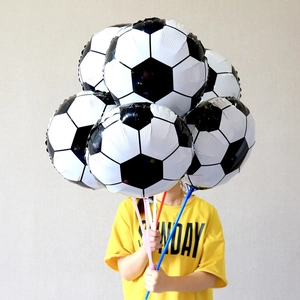 Child holding a cluster of 18-inch soccer foil balloons with colorful handheld sticks