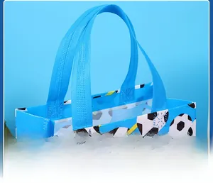 Close-up of reinforced wide handles and football patterns on blue non-woven gift bag