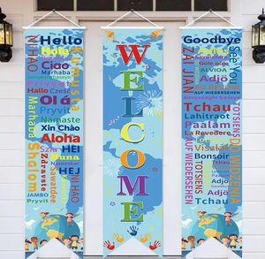 Close-up of Welcome banner set with world map and global multilingual greetings on a white door