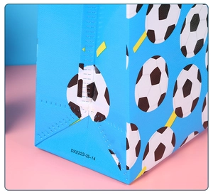 Detailed macro view of soccer pattern non-woven gift bag showing bottom corner stitching