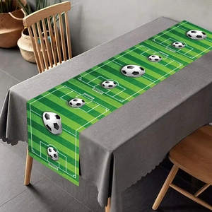 Close-up of football field themed table runner with green grass pattern and 3D soccer ball