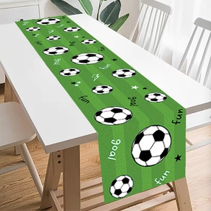 Close-up of football field table runner with green grass texture and soccer patterns