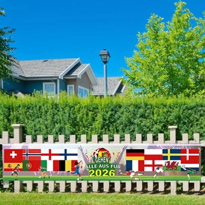 2026 Football World Cup banner with multi-nation flags on white fence under blue sky