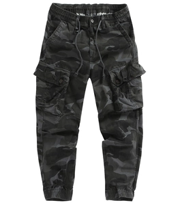 Detail of dark camouflage cargo joggers featuring elastic waist and large tactical flap pockets