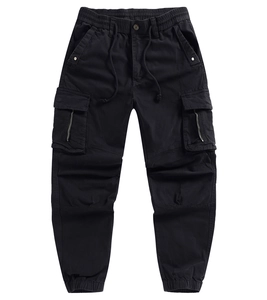 Detail of black cargo pants featuring elastic drawstring waist and side zip pockets