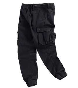 Detail of black cargo pants featuring elastic drawstring waist and large tactical flap pockets