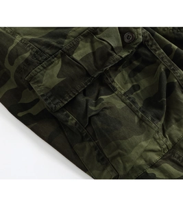 Close-up of jungle camouflage cargo pants with utility pocket and engraved button detail