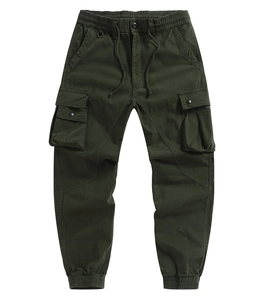 Detail of army green cargo pants featuring elastic waist with drawstring and a metal D-ring