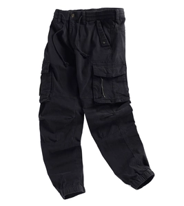 Detail view of black cargo pants featuring elastic drawstring waist and flap pockets