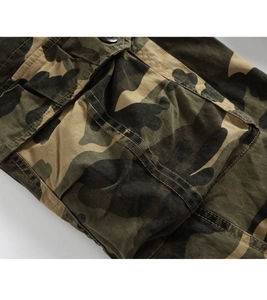 Detailed close-up of jungle camouflage cargo pants featuring a durable utility flap pocket