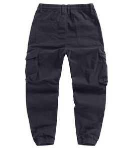 Detail view of dark grey cargo pants featuring functional flap pockets and ribbed cuffs