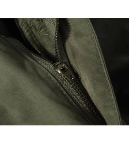 Close-up of durable military green fabric with high-quality metal zipper detail