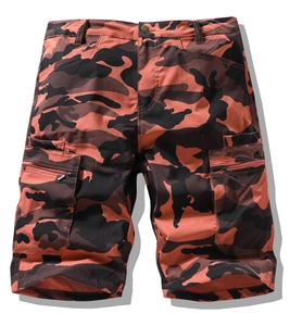 Macro view of orange camo cargo shorts featuring ripstop fabric and zipper pockets