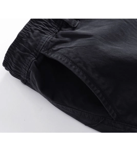 Close-up of elastic waistband and reinforced side pockets on washed cargo pants