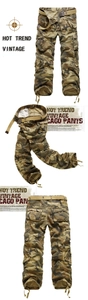 Detail of vintage woodland camouflage cargo pants featuring large side pockets and drawstring hem