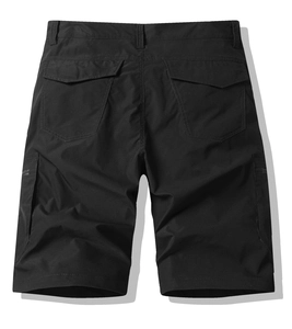 Detail view of the back of black cargo shorts with large flap pockets and cotton fabric