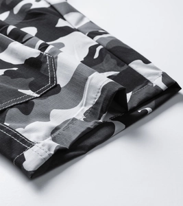 Detail of ripstop camouflage fabric with durable white double-needle stitching on seams