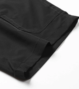 Close-up of black ripstop cargo shorts showing textured fabric and double-stitched hem