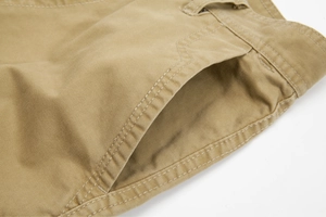 Close-up of khaki cargo pants detailing twill fabric, side pockets and reinforced stitching