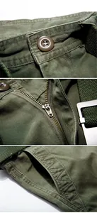 Detail of olive green cargo shorts featuring metal zipper fly and durable twill fabric