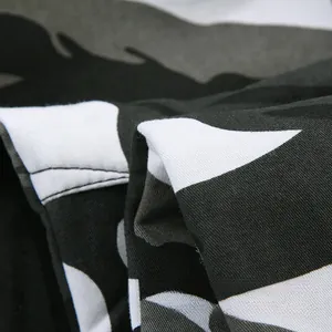 Detail shot of winter camouflage fabric showing thick twill texture in grey and black