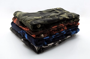 Stacked cargo shorts showing green, red, and blue camo patterns and metal buttons