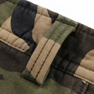 Close-up of winter camo cargo pants featuring reinforced belt loops and durable stitching