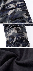 Detail of warm camouflage cargo pants showing flap pocket and thick fleece lining texture